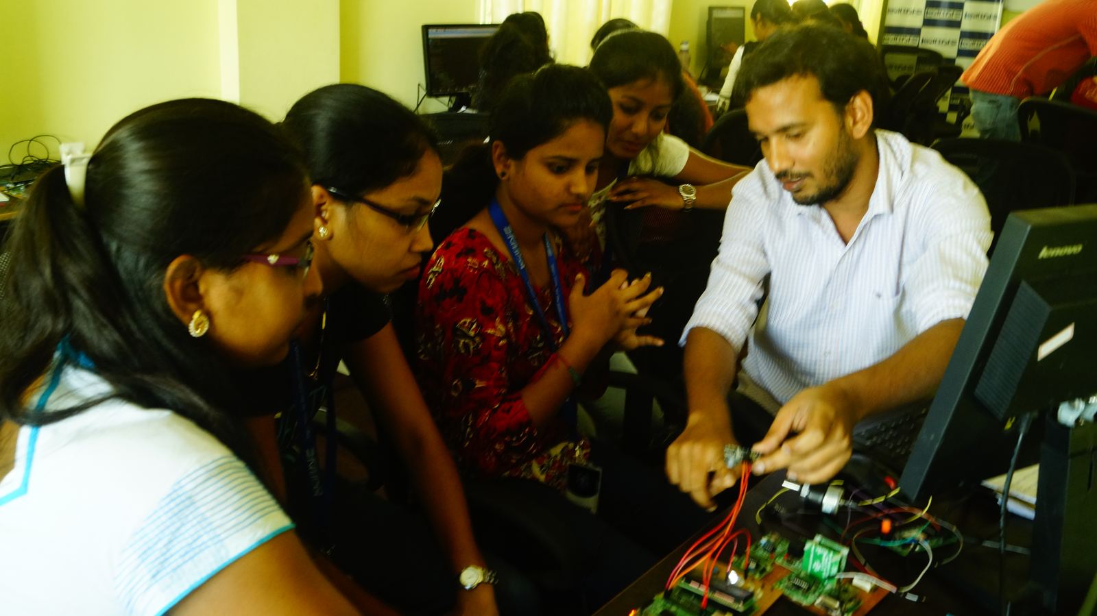 Interns working on embedded hardware with a mentor